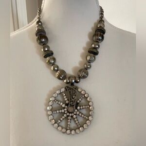 Silver tone beaded necklace with spur pendant.
